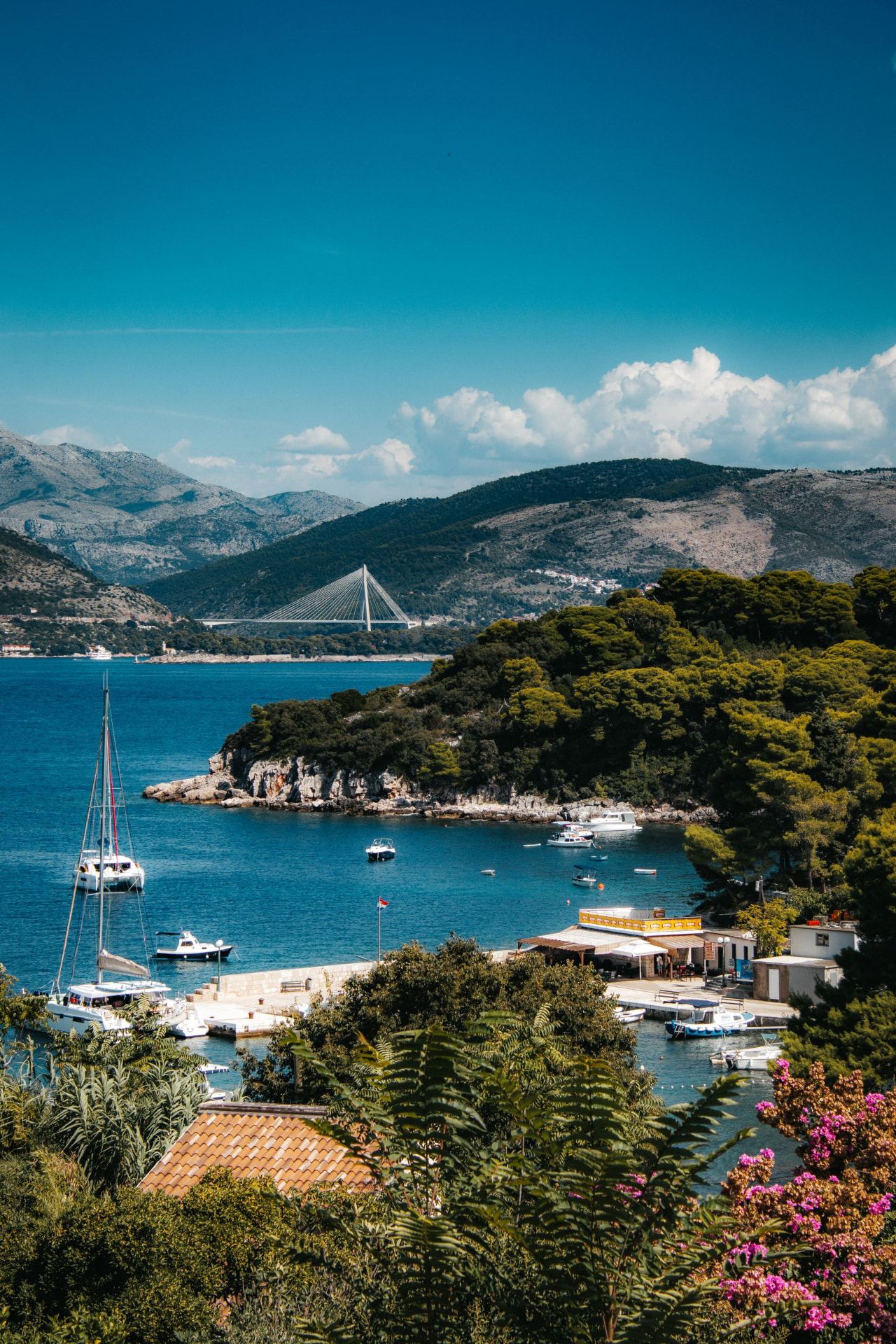 View across a blue bay towards the Franjo Tuđman Bridge