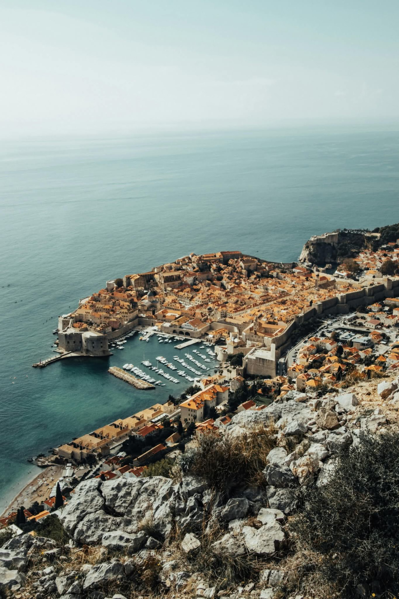 High view of Dubrovnik Old Town, city walls and harbour beside the Adriatic