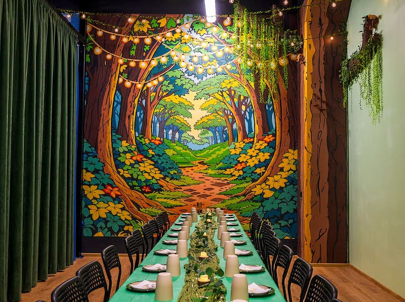 Enchanted forest themed party room with a long decorated table at Adventure Kingdom
