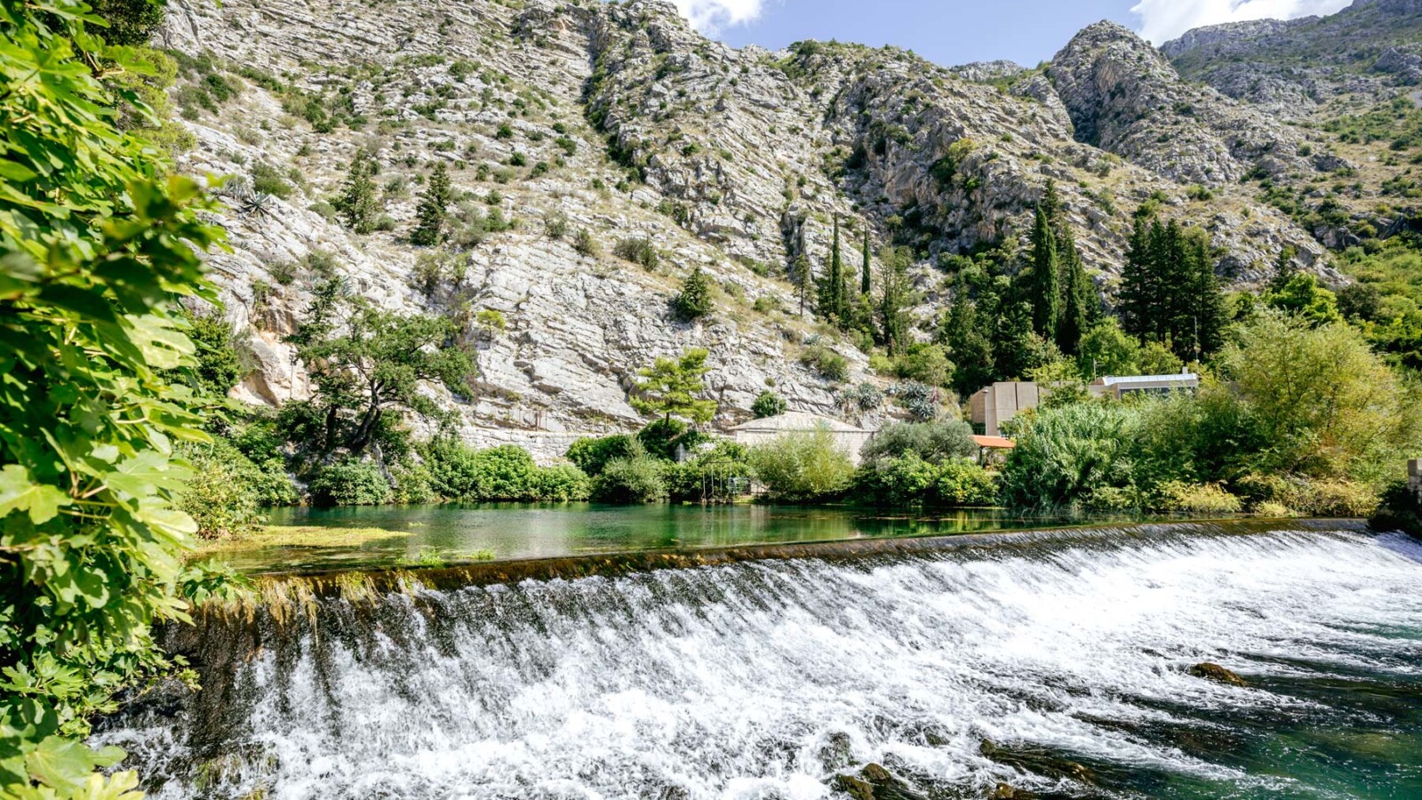 River Ombla flowing beneath dramatic limestone cliffs